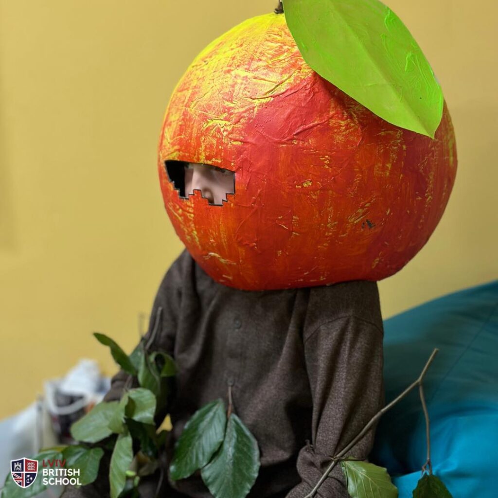 Boy wears a pumpkin helmet at the event
