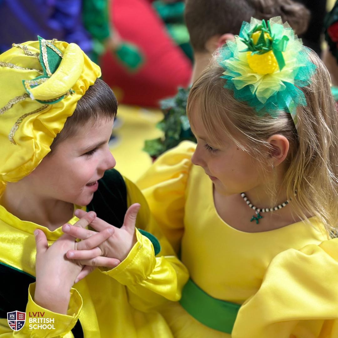 Two girls in yellow outfits chat